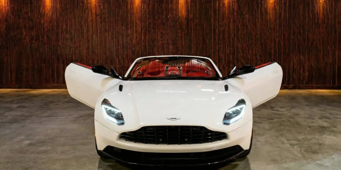White Aston Martin DB11 with convertible roof for sports car rental