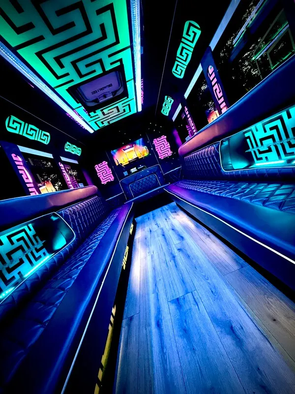 Ford E-450 Series Party BUS interior with perimeter lounge seating, LED accent lighting and LED ceiling lighting for party bus rental