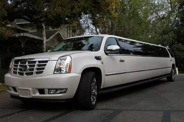 White Cadillac Escalade Limo with tinted windows for limo rental