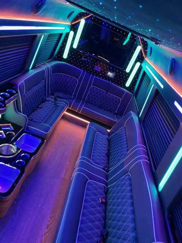 Cadillac Escalade Limousine interior with sofa-style seating, window shades and LED accent lighting for limo rental