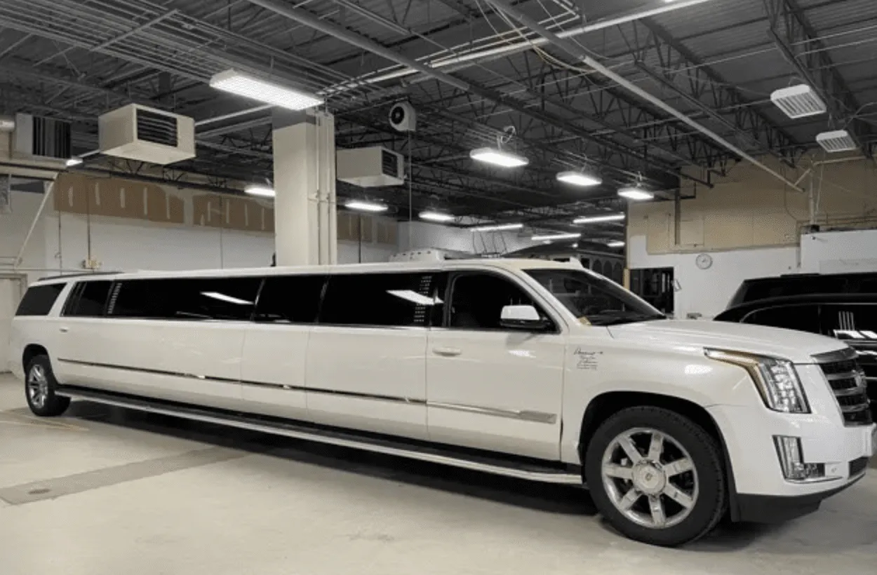 White Cadillac Escalade Limo with tinted windows for limo rental