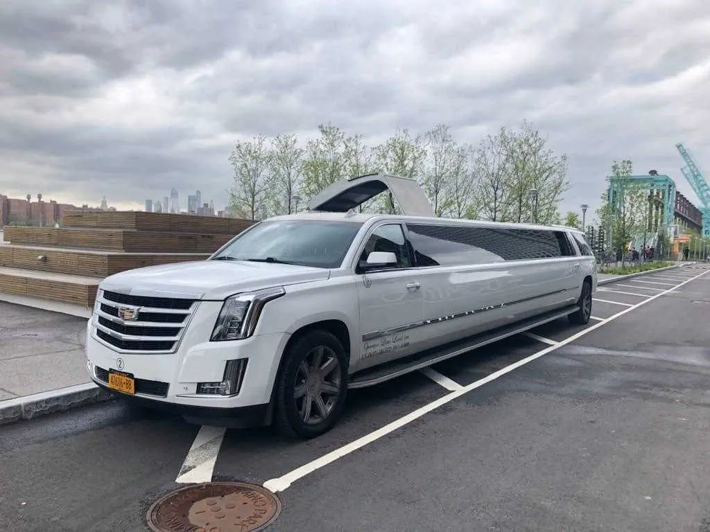 White Cadillac Escalade Limousine with tinted windows for limo rental