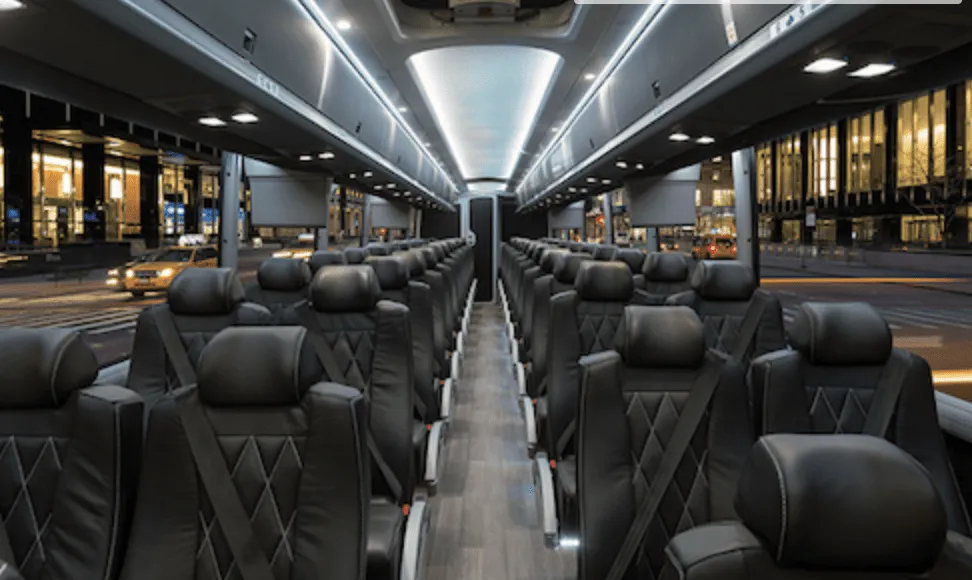56 Passenger Charter Bus 56 Passenger Charter Bus interior with LED ceiling lighting, passenger seat belts and overhead parcel racks for charter bus rental