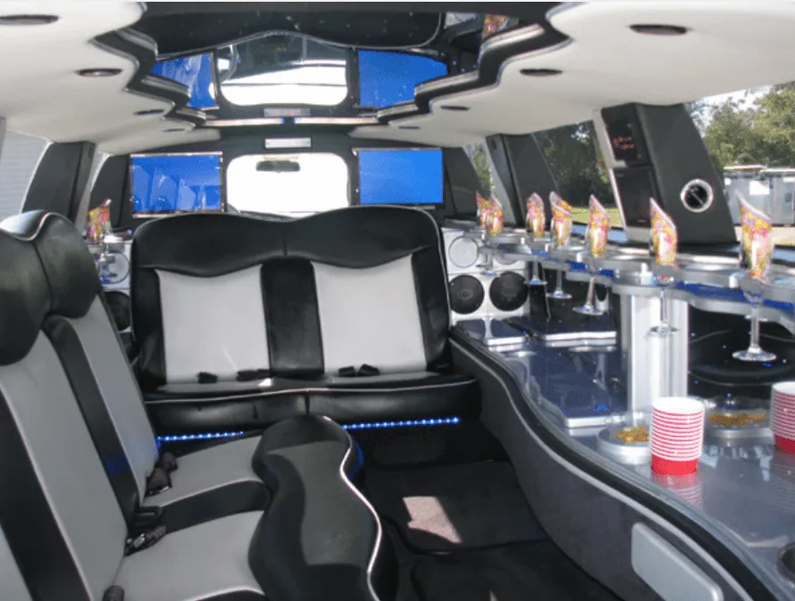 Dodge Charger interior with LED accent lighting, bar area and glassware holders for limo rental