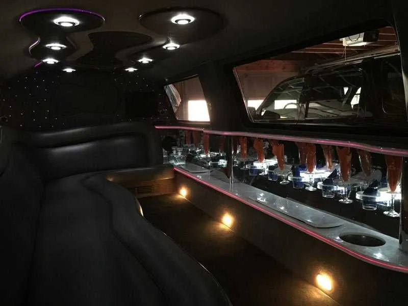 Ford Excursion Limousine interior with LED accent lighting, starlight or fiber-optic ceiling and bar area for limo rental