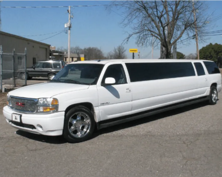 White GMC Denali Limousine exterior with tinted windows for limo rental