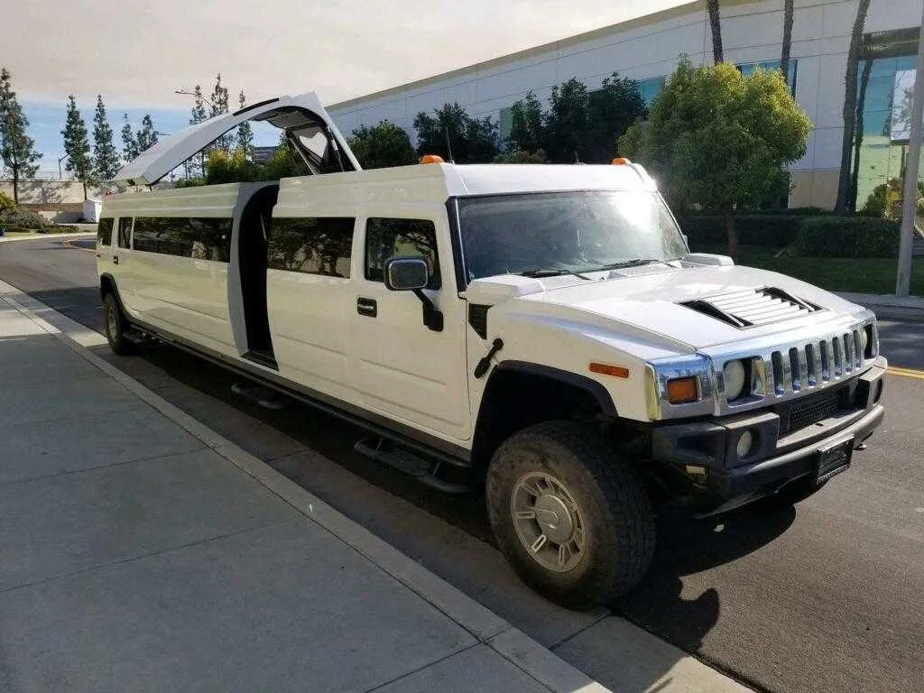 White Hummer Limo exterior with tinted windows and bridal (jet) door for limo rental