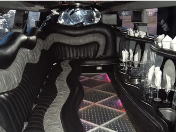 Hummer Limousine cabin – lit dance floor and bar area
