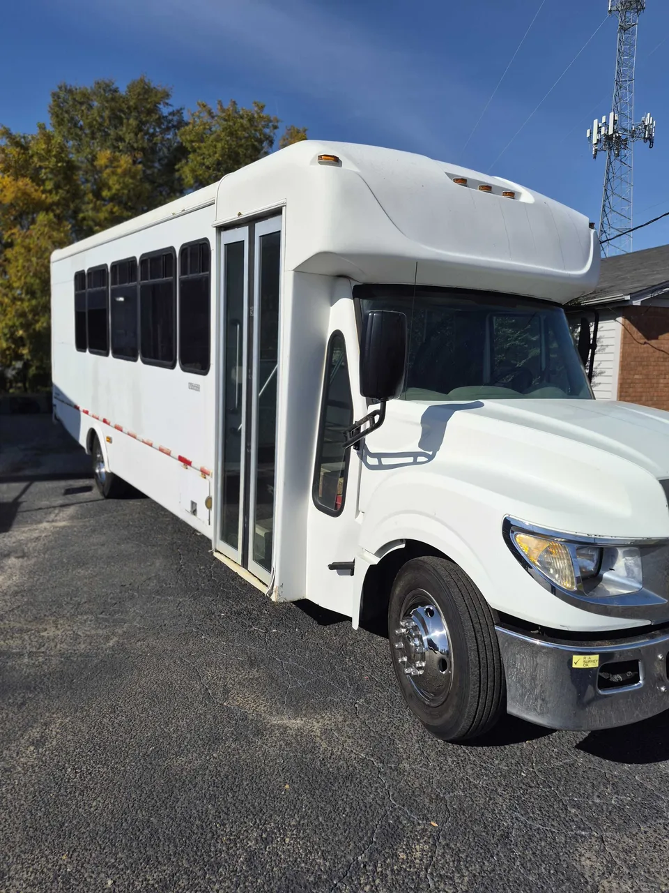 Silver 32 Passenger Limo Bus exterior with tinted windows, photo 4 for party bus rental