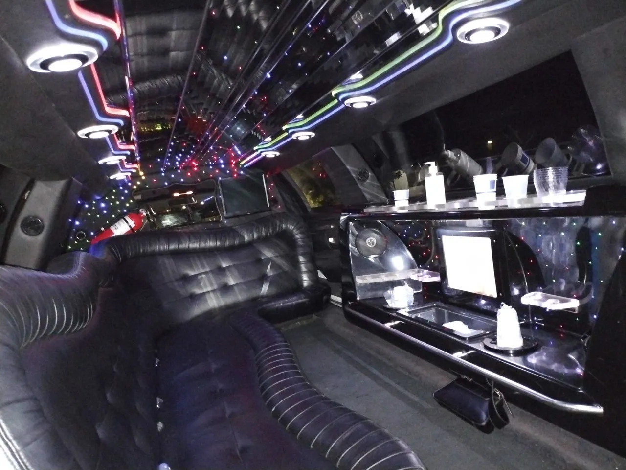 Lincoln Limousine interior with LED ceiling lighting, starlight or fiber-optic ceiling and bar area for limo rental