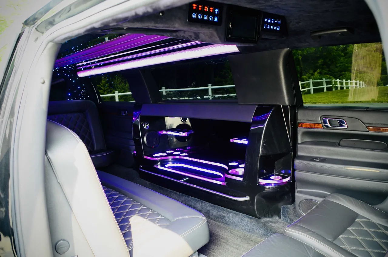 Lincoln MKT Limo interior with LED accent lighting, LED ceiling lighting and bar area for limo rental