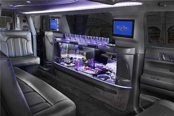 Lincoln MKT Limo interior with LED accent lighting, bar area and glassware holders for limo rental