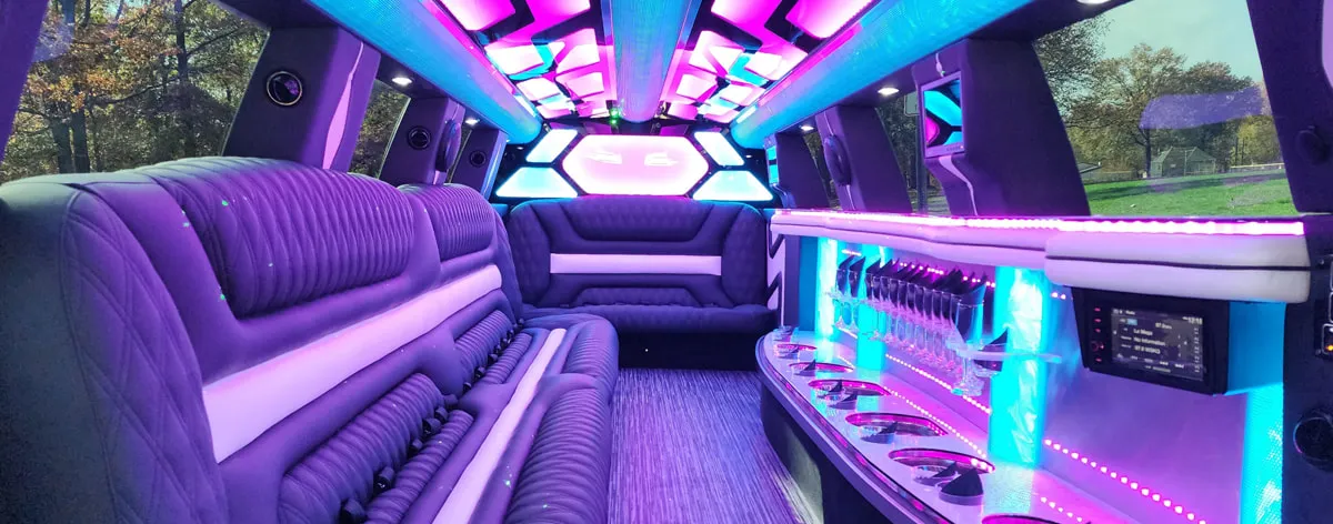 LINCOLN NAVIGATOR (22 Passengers) interior with LED accent lighting, LED ceiling lighting and bar area for limo rental