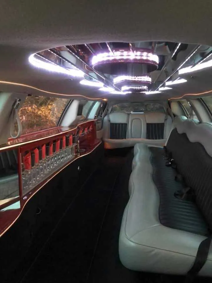 Lincoln Towncar interior with LED ceiling lighting and bar area for limo rental
