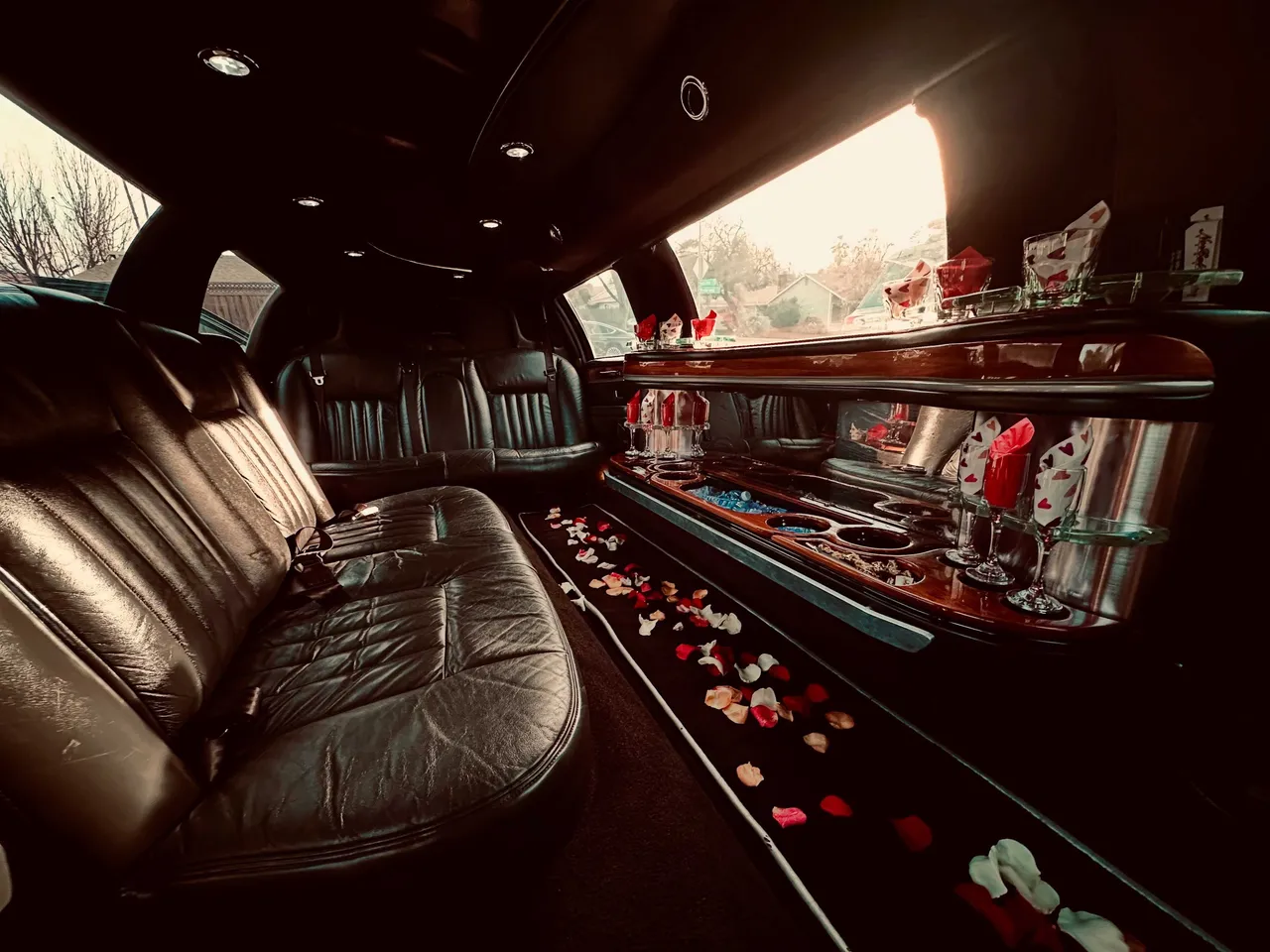 Lincoln Towncar Limo interior with perimeter lounge seating, cup holders and bar area for limo rental