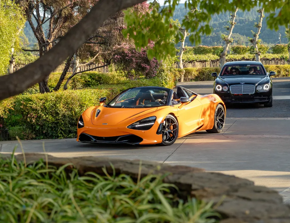 Orange McLaren 720s Performance Spider exterior with convertible roof for sports car rental