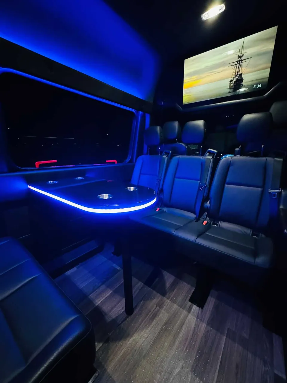 Mercedes Executive Sprinter interior with passenger tables, LED accent lighting and wood-look flooring, photo 3 for party bus rental