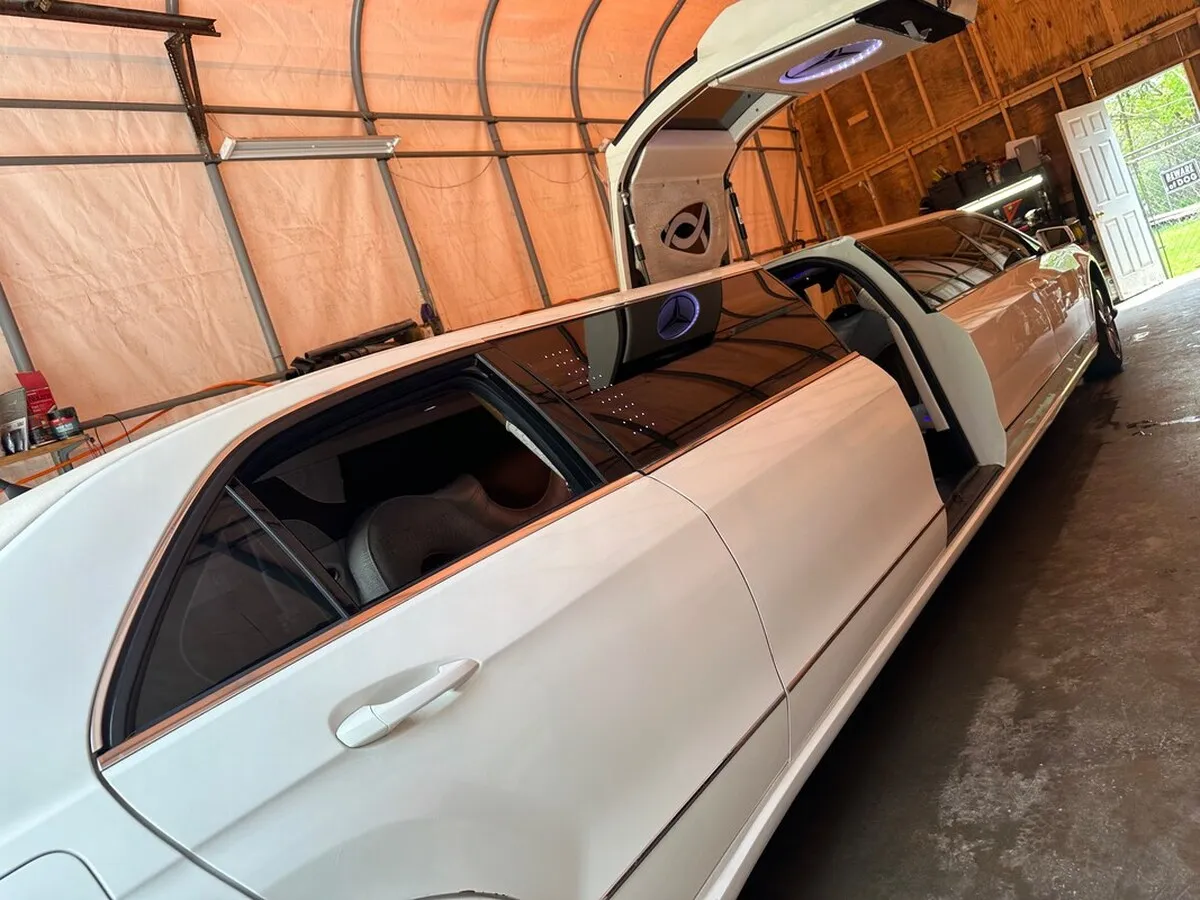 White Mercedes JET Doors Limousine exterior with tinted windows and bridal (jet) door for limo rental