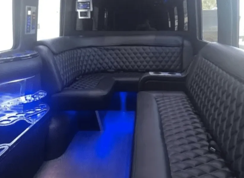 Mercedes Limo Sprinter interior with sofa-style seating, cup holders and LED accent lighting for party bus rental