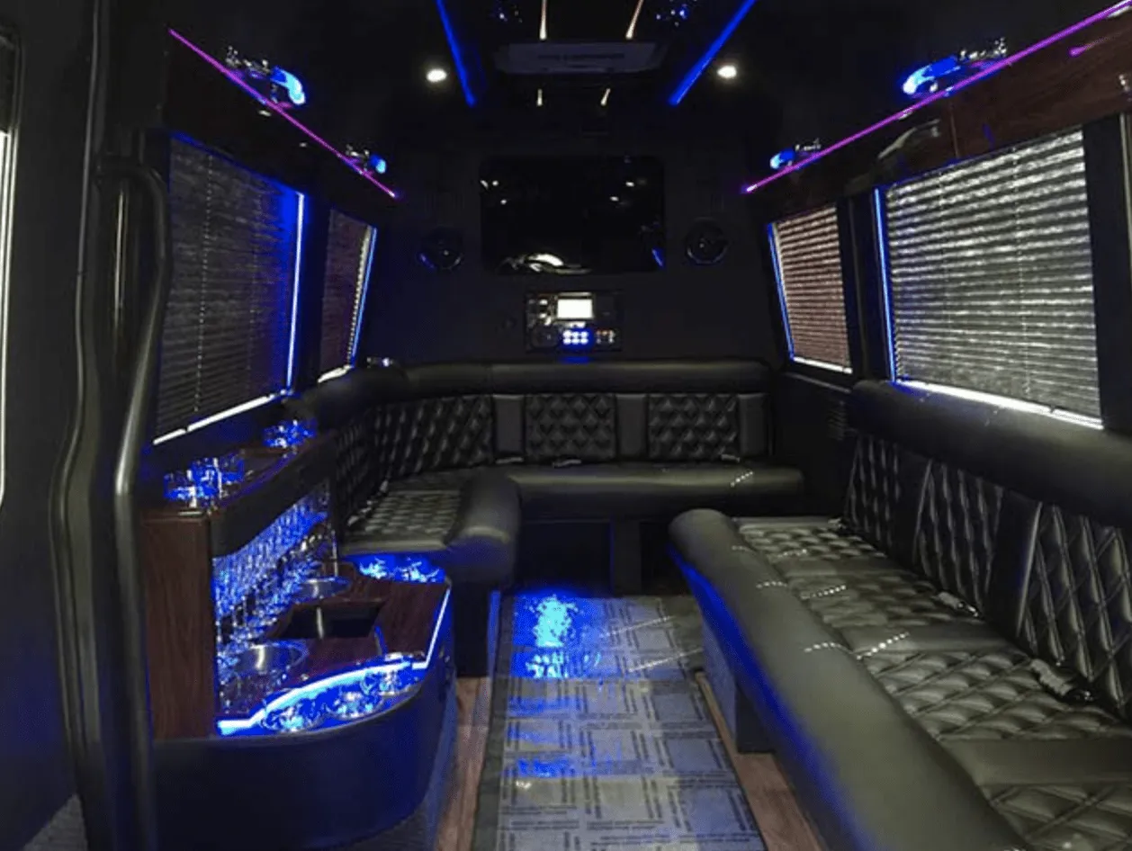 Mercedes Limo Sprinter interior with perimeter lounge seating, window shades and LED accent lighting for party bus rental
