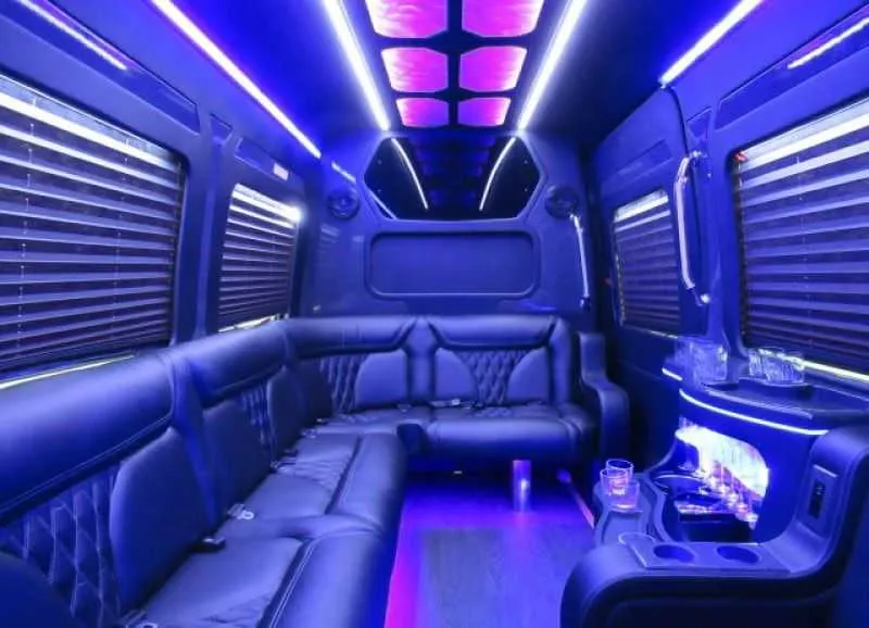 Mercedes Limo Sprinter interior with perimeter lounge seating, window shades and LED accent lighting for party bus rental