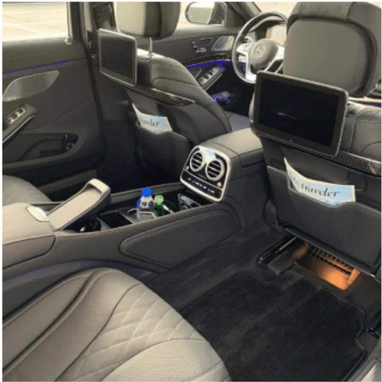 Mercedes Maybach interior with cup holders, LED accent lighting and rear-seat entertainment screens for wedding car rental