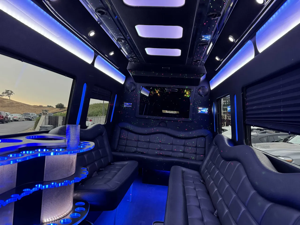 Mercedes Party Bus interior with perimeter lounge seating, window shades and LED accent lighting, photo 5 for party bus rental
