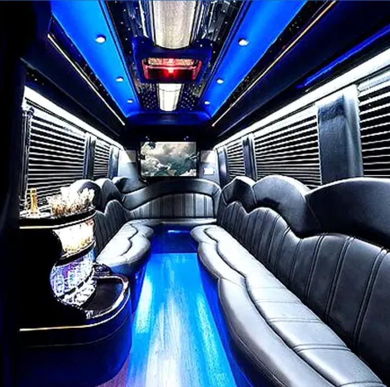 Mercedes Sprinter Limo interior with perimeter lounge seating, sofa-style seating and window shades for party bus rental