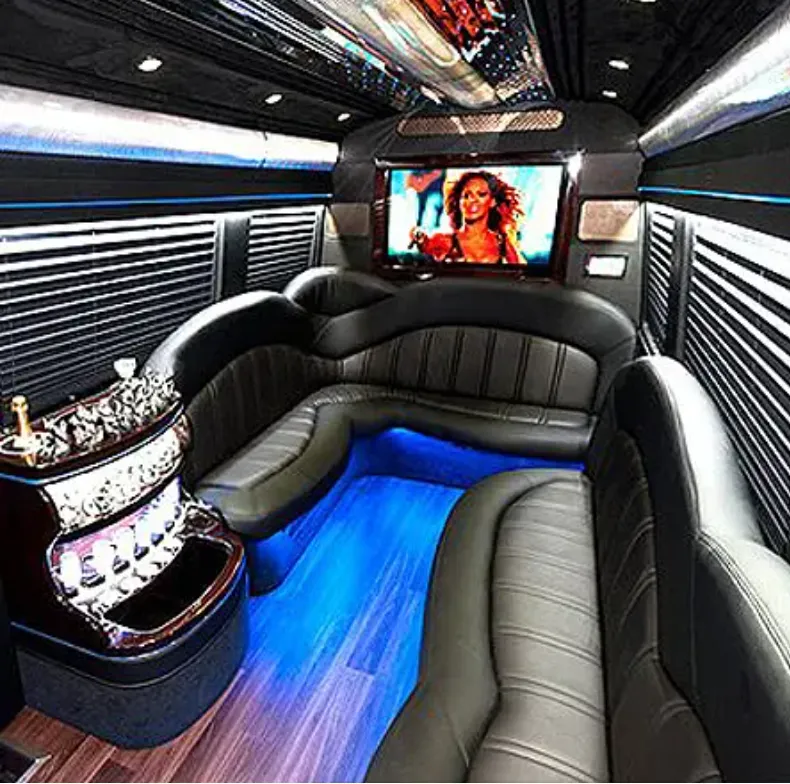 Mercedes Sprinter Limo interior with perimeter lounge seating, window shades and LED accent lighting for party bus rental