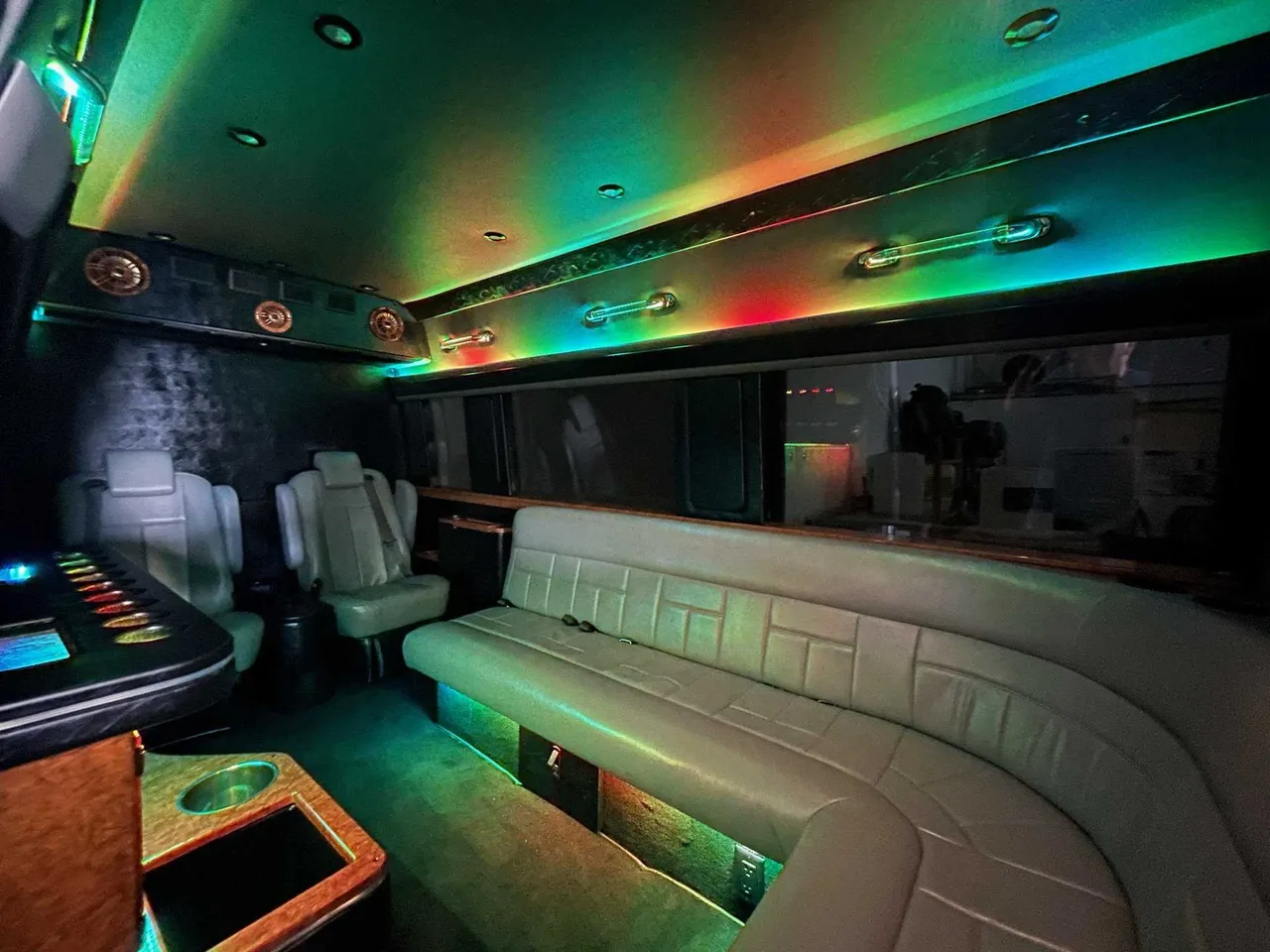 Mercedes Sprinter Limo Mercedes Sprinter Limo interior with sofa-style seating, captain's chairs and LED accent lighting for party bus rental
