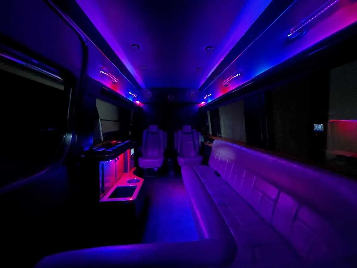 Mercedes Sprinter Limo interior with sofa-style seating, captain's chairs and LED accent lighting, photo 3 for party bus rental