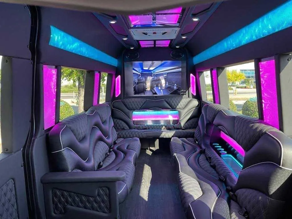 Mercedes Sprinter Limo interior with sofa-style seating, LED accent lighting and LED ceiling lighting for party bus rental