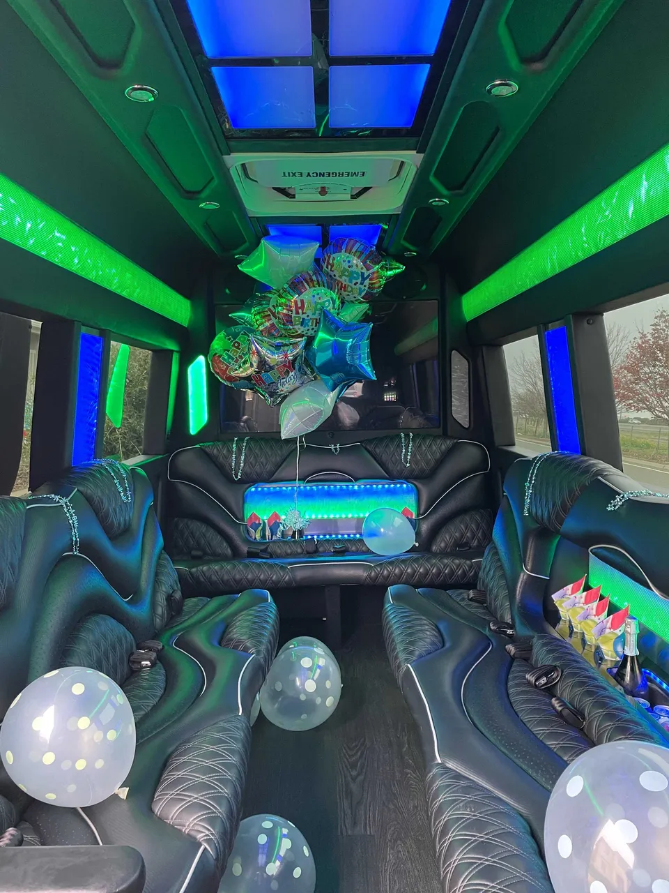 Mercedes Sprinter Limo interior with perimeter lounge seating, LED accent lighting and LED ceiling lighting for party bus rental