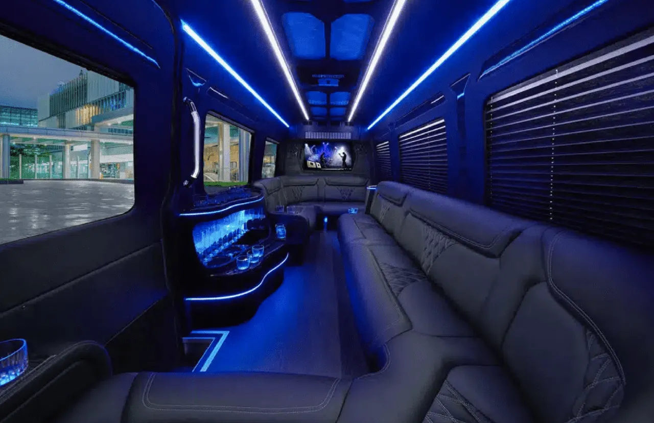 Mercedes Sprinter Limo interior with perimeter lounge seating, window shades and LED accent lighting for party bus rental