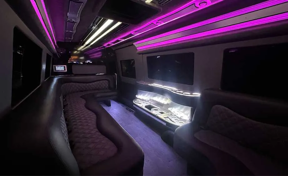 Mercedes Sprinter Limo interior with perimeter lounge seating, LED accent lighting and bar area, photo 3 for party bus rental