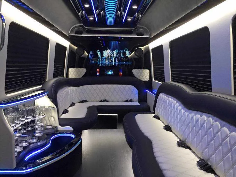 Mercedes Sprinter Limousine interior with perimeter lounge seating, sofa-style seating and window shades for party bus rental