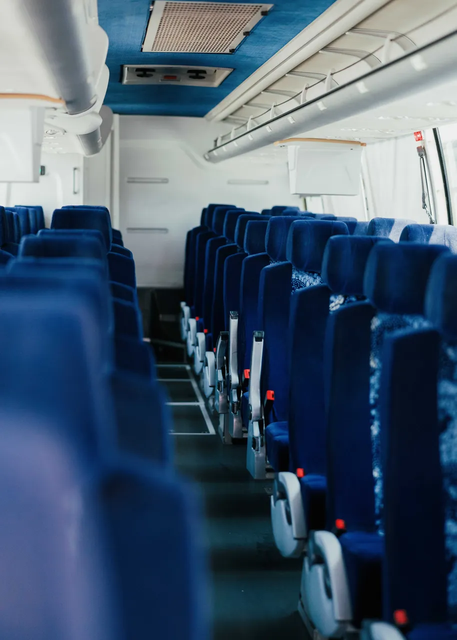 56 Passenger Motor Coach interior with overhead parcel racks for charter bus rental
