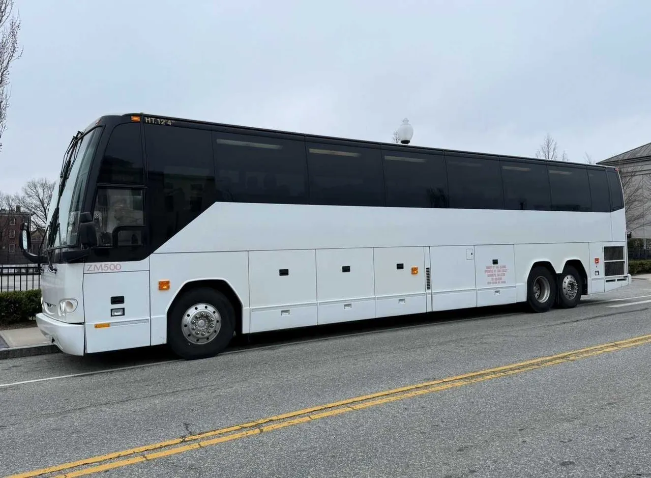 55 Passenger Motorcoach White 55 Passenger Motorcoach with tinted windows for charter bus rental