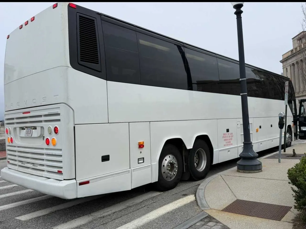 White 55 Passenger Motorcoach exterior with tinted windows, photo 3 for charter bus rental