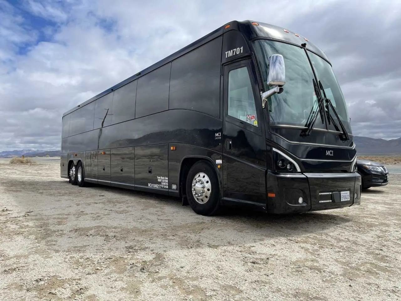 Black 56 Passenger Motorcoach exterior with tinted windows for charter bus rental