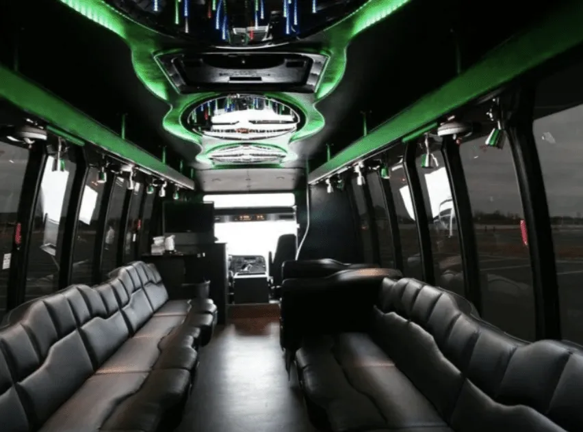 28 Passenger Party Bus interior with perimeter lounge seating, LED accent lighting and LED ceiling lighting for party bus rental