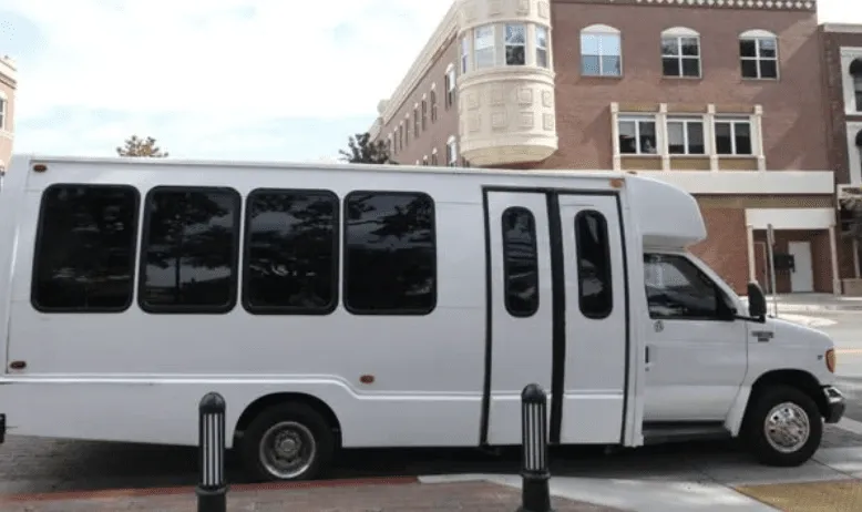 White 16 Passenger Party Bus exterior with tinted windows for party bus rental