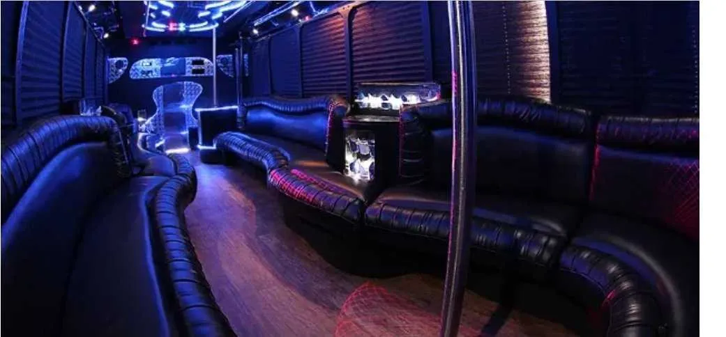 30 Passenger Party Bus interior with perimeter lounge seating, window shades and LED accent lighting for party bus rental