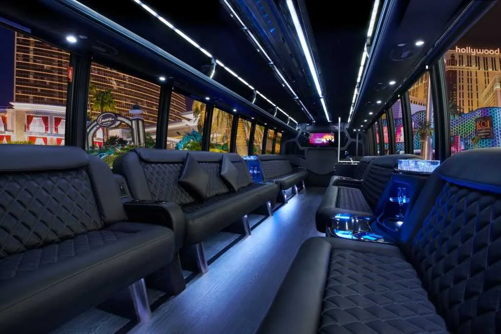 30 Passenger Party Bus interior with perimeter lounge seating, LED accent lighting and LED ceiling lighting for party bus rental
