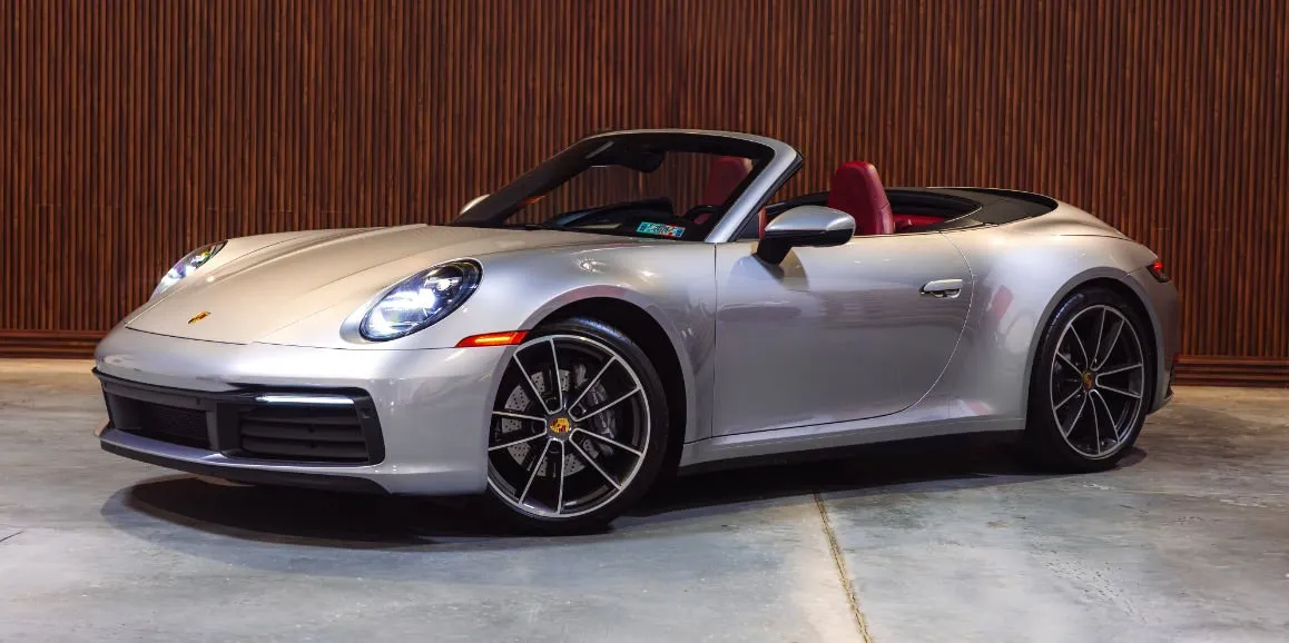 Silver Porsche 911 with convertible roof for sports car rental
