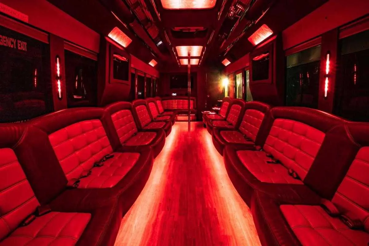 Tiffany Party Bus interior with perimeter lounge seating, LED accent lighting and LED ceiling lighting for party bus rental