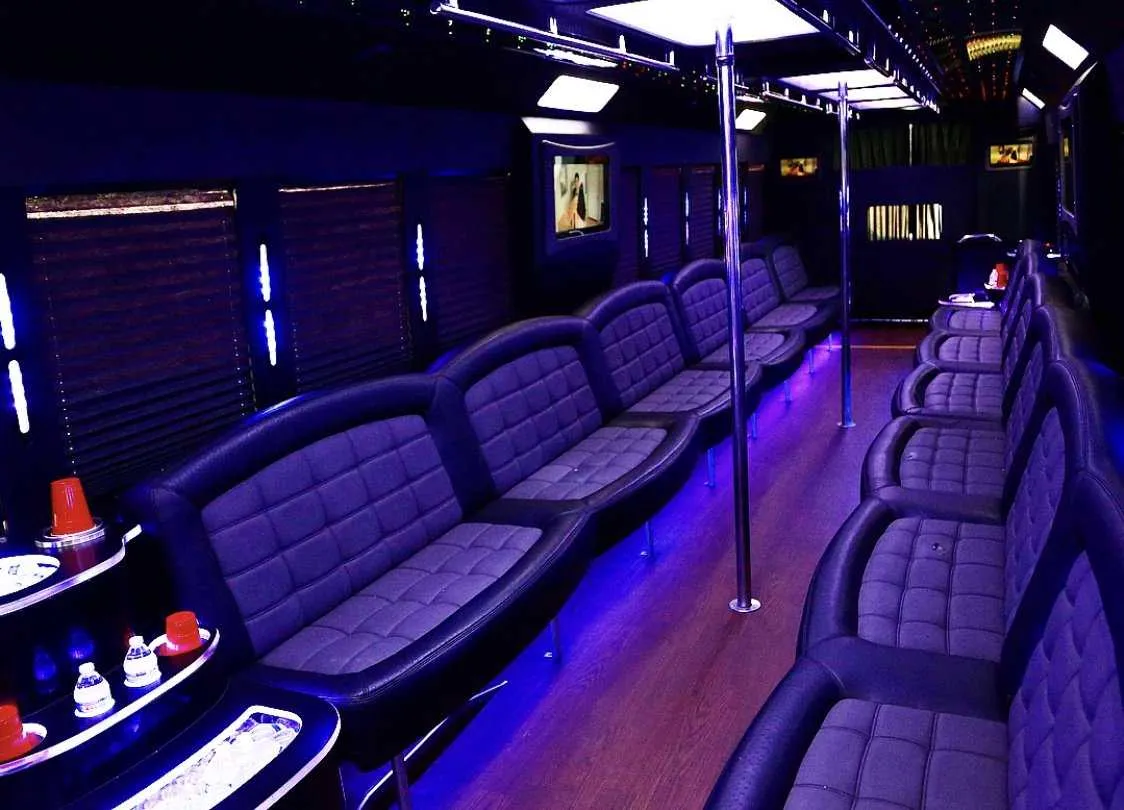 Tiffany Party Bus interior with perimeter lounge seating, window shades and LED accent lighting for party bus rental